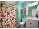 Bright bathroom features a colorful shower curtain, updated vanity, and stylish decor at 610 Redwood Dr, Pendleton, IN 46064