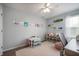 Charming bedroom with pink rug, crafting table, ample toy storage, and plenty of natural light at 610 Redwood Dr, Pendleton, IN 46064