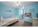 Bright bedroom featuring a bed, white furniture, and light blue walls with colorful decorations and photos at 610 Redwood Dr, Pendleton, IN 46064