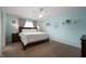 Bedroom with light blue walls, a ceiling fan, and a large bed with two bedside tables and lamps at 610 Redwood Dr, Pendleton, IN 46064