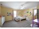 bedroom with yellow walls featuring a white bed, desk, and decorative rainbow wall art at 610 Redwood Dr, Pendleton, IN 46064