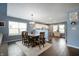 Dining room adjacent to a kitchen with modern lighting and hardwood floors at 610 Redwood Dr, Pendleton, IN 46064