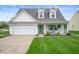 Charming home features a well-manicured lawn, two-car garage, and inviting front porch at 610 Redwood Dr, Pendleton, IN 46064