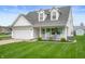Inviting home with a well-kept lawn, two-car garage, and a welcoming front porch at 610 Redwood Dr, Pendleton, IN 46064