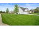 Large, well-maintained front yard showcasing lush green grass at 610 Redwood Dr, Pendleton, IN 46064