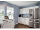 Kitchen featuring stainless steel refrigerator, white cabinets, and granite countertops with natural light at 610 Redwood Dr, Pendleton, IN 46064