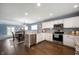Open kitchen featuring stainless appliances, granite counters, white cabinetry and flows to dining area at 610 Redwood Dr, Pendleton, IN 46064