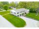 Aerial view of home with expansive front lawn, two car garage, manicured lawn, and mature trees at 6250 Seminole Dr, Indianapolis, IN 46259