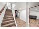 Basement staircase with carpeted treads and open access to a finished living space at 6250 Seminole Dr, Indianapolis, IN 46259