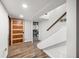 Finished basement hallway featuring modern wood-look flooring, staircase and access to the laundry room at 6250 Seminole Dr, Indianapolis, IN 46259
