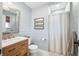 Stylish bathroom with blue shiplap walls, a framed mirror, wood vanity, and a tiled floor at 6250 Seminole Dr, Indianapolis, IN 46259