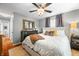 Spacious bedroom with hardwood floors, a ceiling fan, and elegant decor with natural light streaming through windows at 6250 Seminole Dr, Indianapolis, IN 46259