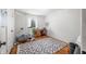 Bright bedroom with hardwood floors, a patterned rug, and a functional workspace with a desk and chair at 6250 Seminole Dr, Indianapolis, IN 46259