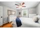 Inviting bedroom featuring hardwood floors, a ceiling fan, and bright natural light streaming through the windows at 6250 Seminole Dr, Indianapolis, IN 46259