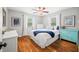Cozy bedroom featuring hardwood floors, a ceiling fan, a comfortable bed, and bright, natural light at 6250 Seminole Dr, Indianapolis, IN 46259