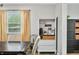 Bright dining area with built-in coffee bar, wood table, and stylish storage at 6250 Seminole Dr, Indianapolis, IN 46259