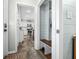 Inviting entryway featuring a mudroom bench and an open view of the kitchen with modern, white cabinets at 6250 Seminole Dr, Indianapolis, IN 46259