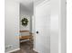 Bright, inviting entryway with a decorative wreath, bench, and modern white door, creating a warm welcome at 6250 Seminole Dr, Indianapolis, IN 46259
