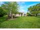Well-maintained exterior with a lush green lawn, beautiful tree, and stone facade, showcasing the property's appeal at 6250 Seminole Dr, Indianapolis, IN 46259