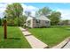 Charming exterior showcasing manicured lawn, walkway, and stone facade, creating a welcoming curb appeal at 6250 Seminole Dr, Indianapolis, IN 46259
