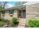 Inviting front entrance with a decorative door, stone exterior, and manicured landscaping for added charm at 6250 Seminole Dr, Indianapolis, IN 46259
