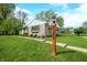 A well maintained front yard with manicured bushes and green grass, complemented by a stone facade home at 6250 Seminole Dr, Indianapolis, IN 46259