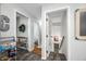 Charming hallway featuring unique decor and a view leading to a brightly lit staircase and other rooms at 6250 Seminole Dr, Indianapolis, IN 46259