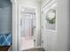 Hallway with a view of a bathroom with blue shiplap walls, wood vanity, and a tiled floor at 6250 Seminole Dr, Indianapolis, IN 46259