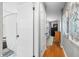 Hallway leading to a bedroom and bathroom showcasing hardwood floors and an open and airy atmosphere at 6250 Seminole Dr, Indianapolis, IN 46259