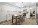 Bright kitchen with white cabinets, stainless steel appliances, kitchen island, and tiled backsplash at 6250 Seminole Dr, Indianapolis, IN 46259