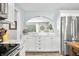 Bright kitchen featuring marble counters, white cabinets, and stainless steel refrigerator at 6250 Seminole Dr, Indianapolis, IN 46259