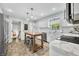 Charming kitchen with white cabinets, stainless steel appliances, island table, and tiled backsplash at 6250 Seminole Dr, Indianapolis, IN 46259