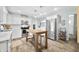 Bright kitchen with white cabinets, stainless steel appliances, kitchen island, and tiled backsplash at 6250 Seminole Dr, Indianapolis, IN 46259