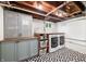 Finished laundry room with modern appliances, stylish flooring, cabinets, and wooden countertop at 6250 Seminole Dr, Indianapolis, IN 46259
