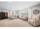 Cozy living room with ample seating, neutral tones, and large windows with natural light at 6250 Seminole Dr, Indianapolis, IN 46259