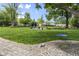 Lush backyard featuring a basketball court, swing set, and fire pit area, ideal for outdoor fun at 6288 Buttonwood Dr, Noblesville, IN 46062