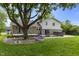 A backyard featuring a home, a hot tub, a patio and a large tree at 6288 Buttonwood Dr, Noblesville, IN 46062
