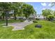 Landscaped backyard featuring a basketball court, firepit, and mature trees at 6288 Buttonwood Dr, Noblesville, IN 46062