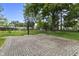 Paved basketball court in a landscaped backyard offers recreational opportunities at 6288 Buttonwood Dr, Noblesville, IN 46062