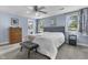 Comfortable bedroom with a ceiling fan, two windows, sitting bench and grey carpet at 6288 Buttonwood Dr, Noblesville, IN 46062