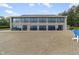 Exterior view of a community clubhouse featuring floor-to-ceiling windows and waterfront access at 6288 Buttonwood Dr, Noblesville, IN 46062