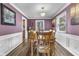 Elegant dining room with chair-rail detail, wooden table set for six, and modern lighting at 6288 Buttonwood Dr, Noblesville, IN 46062