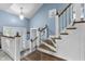 Inviting entryway with a wooden staircase, decorative door, and blue accent wall at 6288 Buttonwood Dr, Noblesville, IN 46062