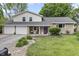 Charming home featuring a stone facade, a two-car garage, and a well-manicured front yard at 6288 Buttonwood Dr, Noblesville, IN 46062