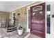 Inviting front porch with stone accents and a pair of rocking chairs near the front door at 6288 Buttonwood Dr, Noblesville, IN 46062