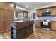 Stylish kitchen with stainless steel appliances, gray backsplash, and a wooden center island at 6288 Buttonwood Dr, Noblesville, IN 46062