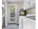 Convenient laundry room with washer, dryer, hot water tank, and exterior access at 6288 Buttonwood Dr, Noblesville, IN 46062