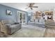 Open-concept living room featuring new flooring, a ceiling fan, and easy access to the kitchen at 6288 Buttonwood Dr, Noblesville, IN 46062