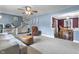 Open floor plan showcasing the staircase from the living room featuring a soft couch and furniture at 6288 Buttonwood Dr, Noblesville, IN 46062