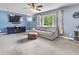 Bright living room with soft lighting, a plush couch, and a flat screen television at 6288 Buttonwood Dr, Noblesville, IN 46062